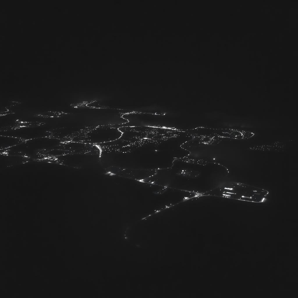 Aerial view of a coastal city lit up at night